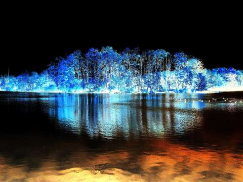 Blue and white land mass floating in a sea of unde