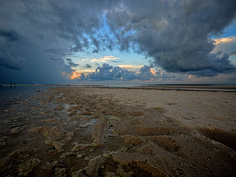 Hole in the clouds on a wet beach