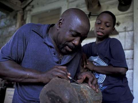 Son Watching Dad Carve
