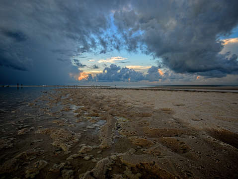 Hole in the clouds on a wet beach 2