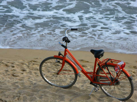 Orange Bicycle On A Beach In Barcelona