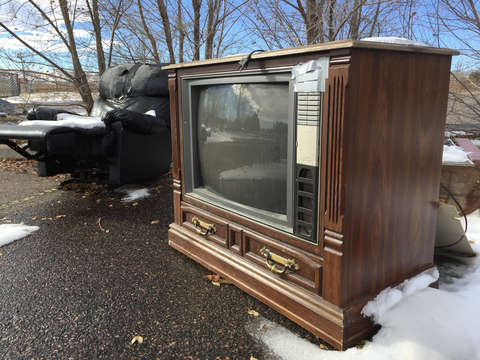 Old tv and recliner in the snow