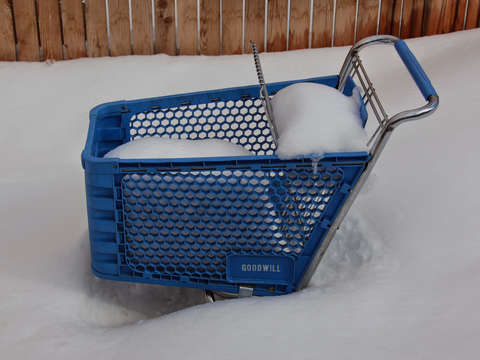 Goodwill shopping basket filled with snow