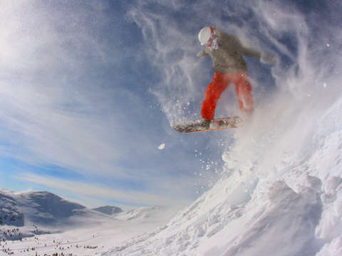 Snowboarder launching at copper mountain