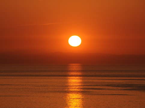Blood red sunrise on water