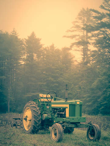 Old john deere tractor early morning fog