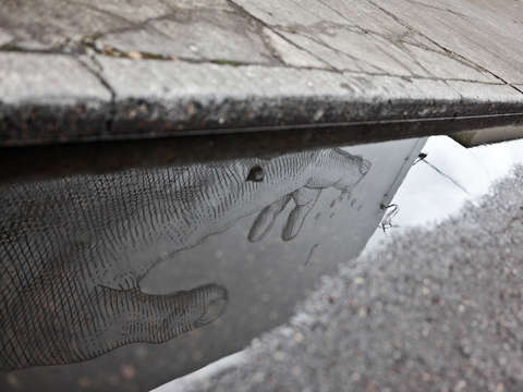 Reflection of giant hand mural