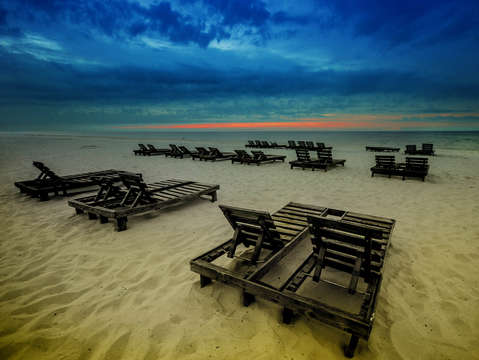 A couple of rows of chairs in blue and yellow