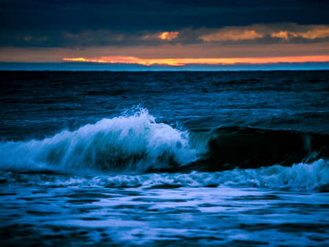 Blue waves and sunrise of the gulf
