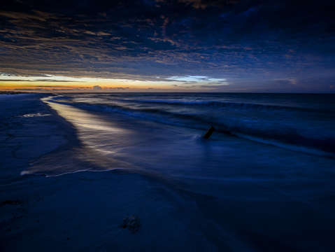 Blanket of clouds over surf