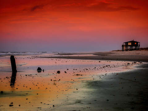 Red sky at the stump and beach house
