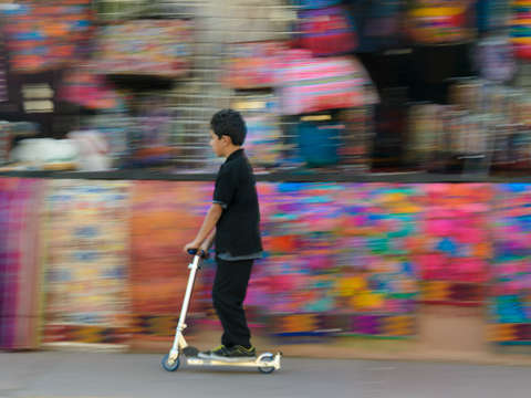 Boy on scooter at market