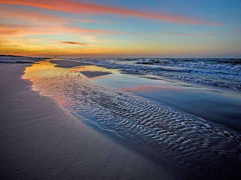 Rippling beach sunrise