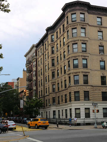 Beautiful building and a taxi in harlem nyc