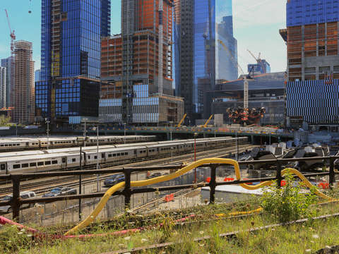Snaking tube along the highline by a rail yard in