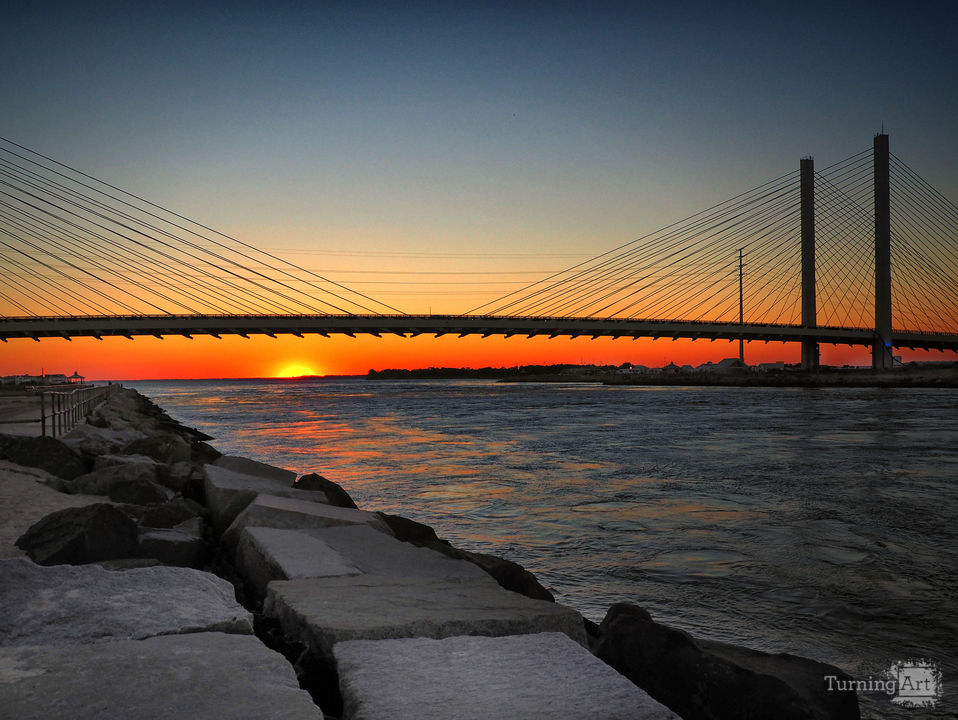 Sunset under the indian river inlet bridge