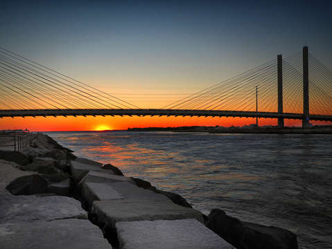 Sunset under the indian river inlet bridge