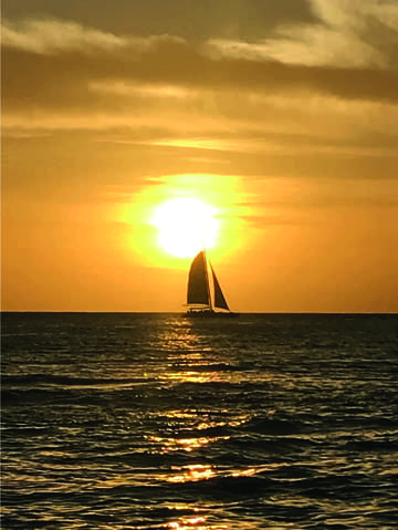 Boat crossing the sunset