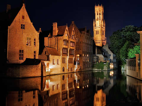 Belfry reflecting in the river dijver