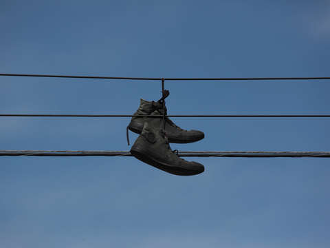 Black shoes on a wire