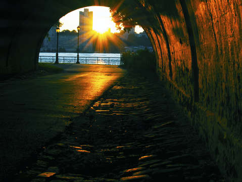 Underpass view of a hudson river sunset