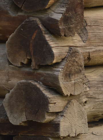 Old handcrafted logs on barn