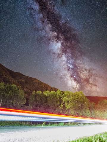 Car lights and milky way