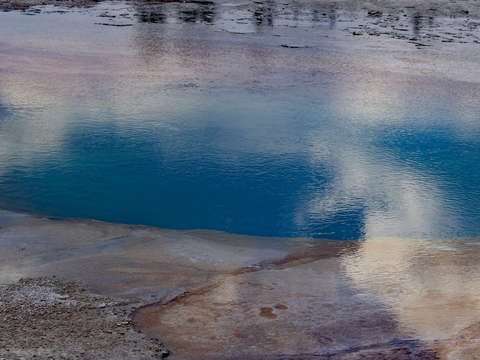 Emerald spring reflecting clouds