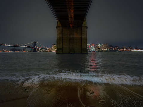 Waves crashing under the brooklyn bridge