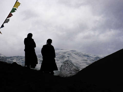Silhouetted women on tibetan plateau