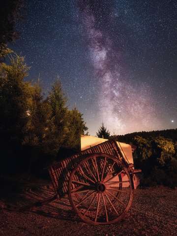 Old horse carriage under the milky way