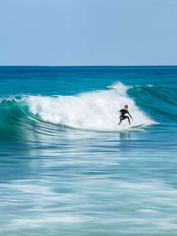 Blue water surfer vertical