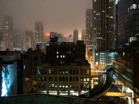 Chicago train with skyline on a foggy night