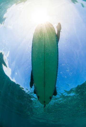 Underwater view of surfer at sunset 3