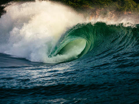 Big wave crashing at sunset