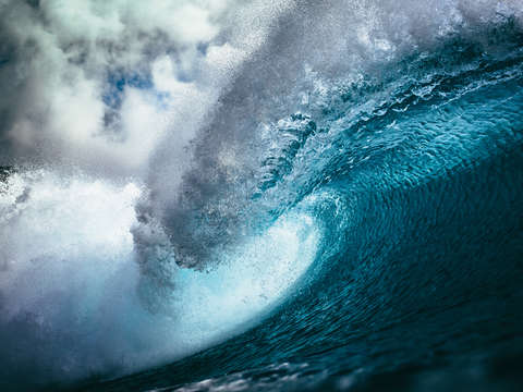 Big blue wave crashing at sunset