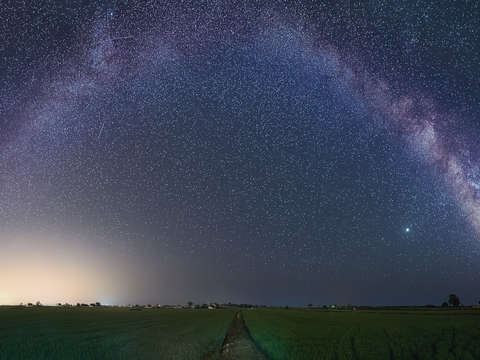 Milky way arch over rice fields