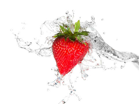 Water splashing on a strawberry