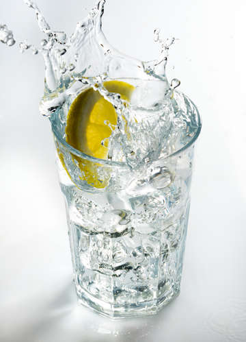 Lemon splashing on a glass