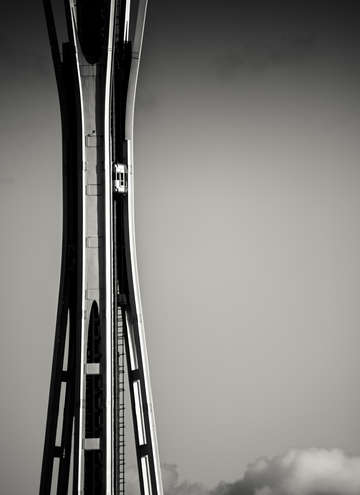 Space Needle elevator rising above the clouds in black and white
