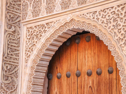 Wooden door with decorative stone carving alhambra