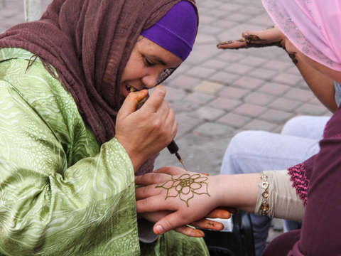 Applying henna