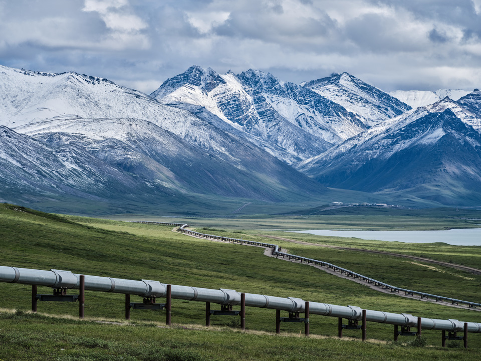 The Alaska Oil Pipeline and a July coating of Snow on the Mountains