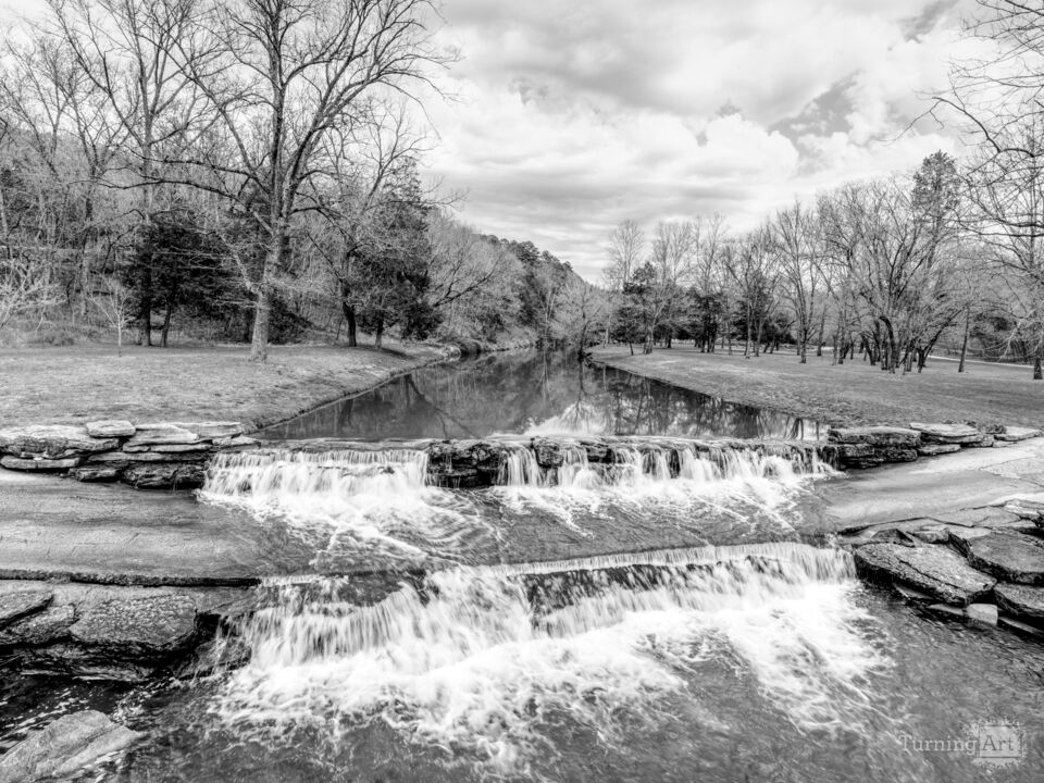 Lampe Waterfalls Over A Road Grayscale