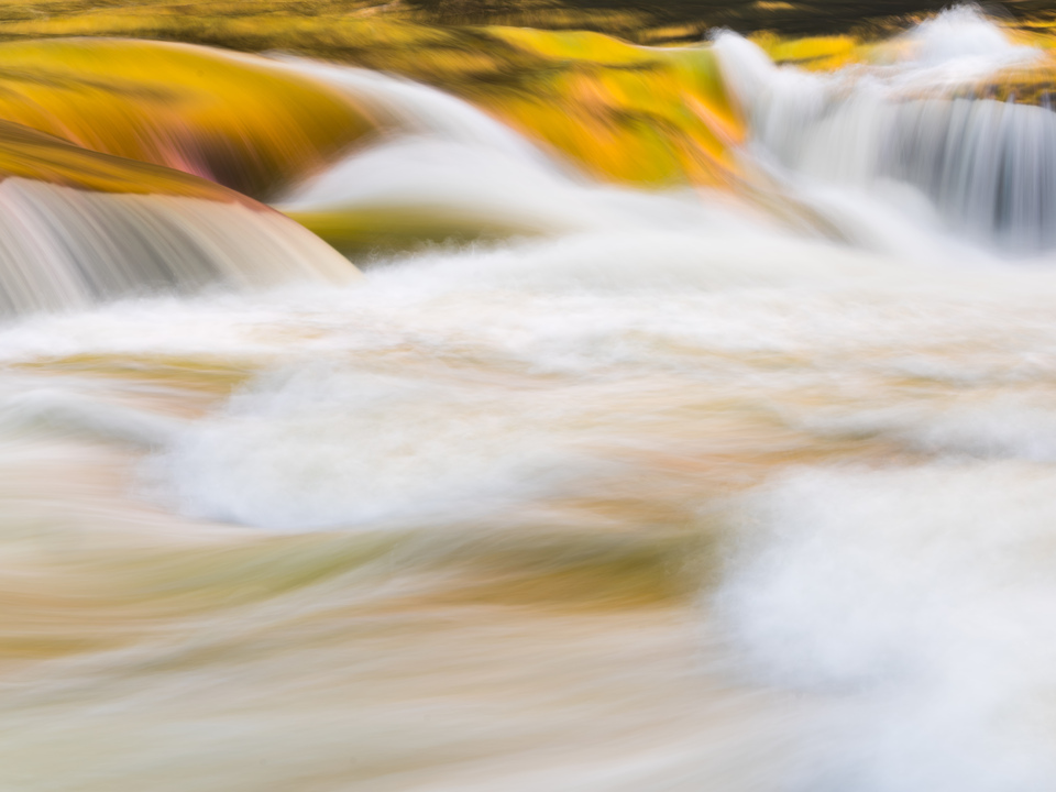 Golden hues in raging waterfall