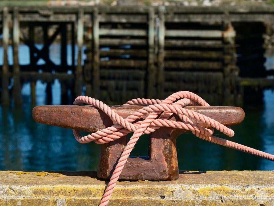Pink Mooring rope on a rusted Dockside Bollard