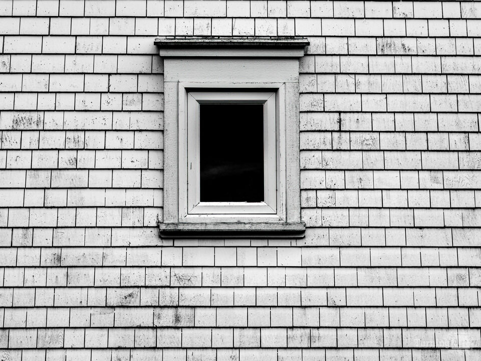 B&W Image of a small Window and weathered siding