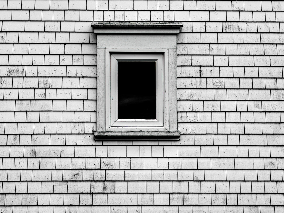 B&W Image of a small Window and weathered siding