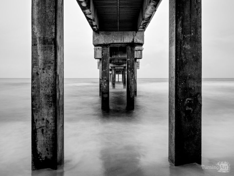 Blue Hour Under Orange Beach Pier Grayscale