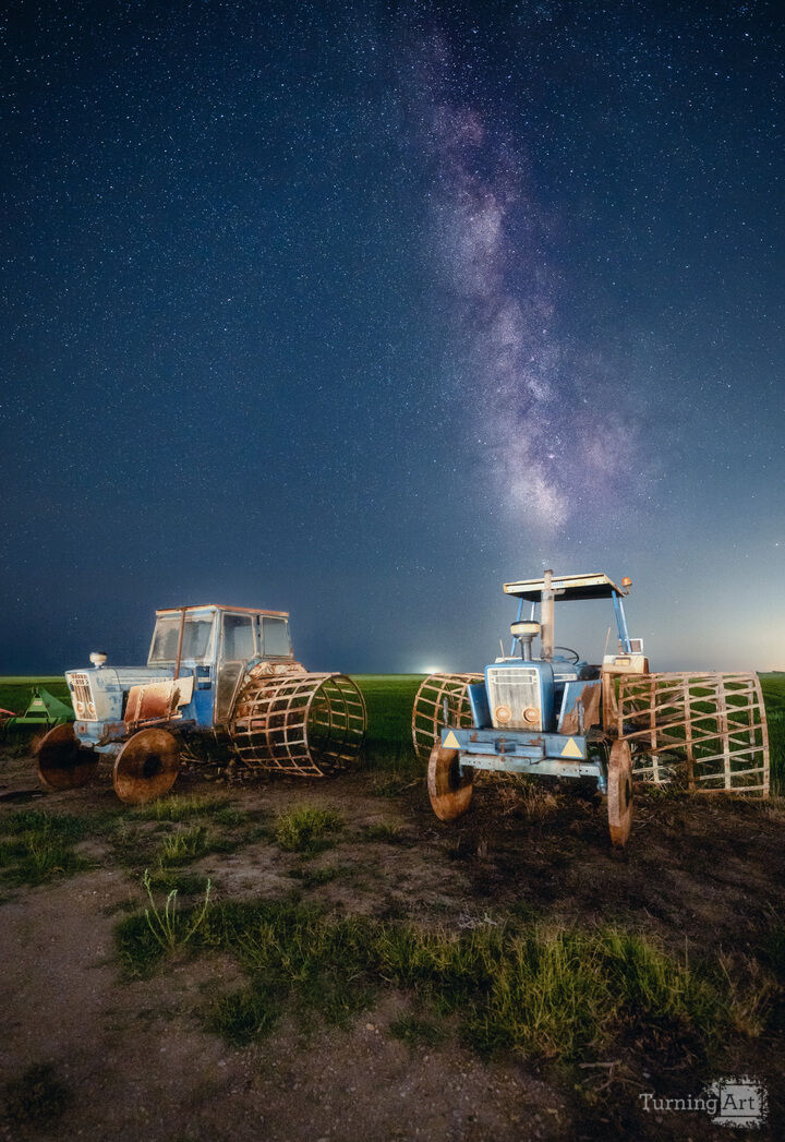 Rusty tractors beneath the starry night
